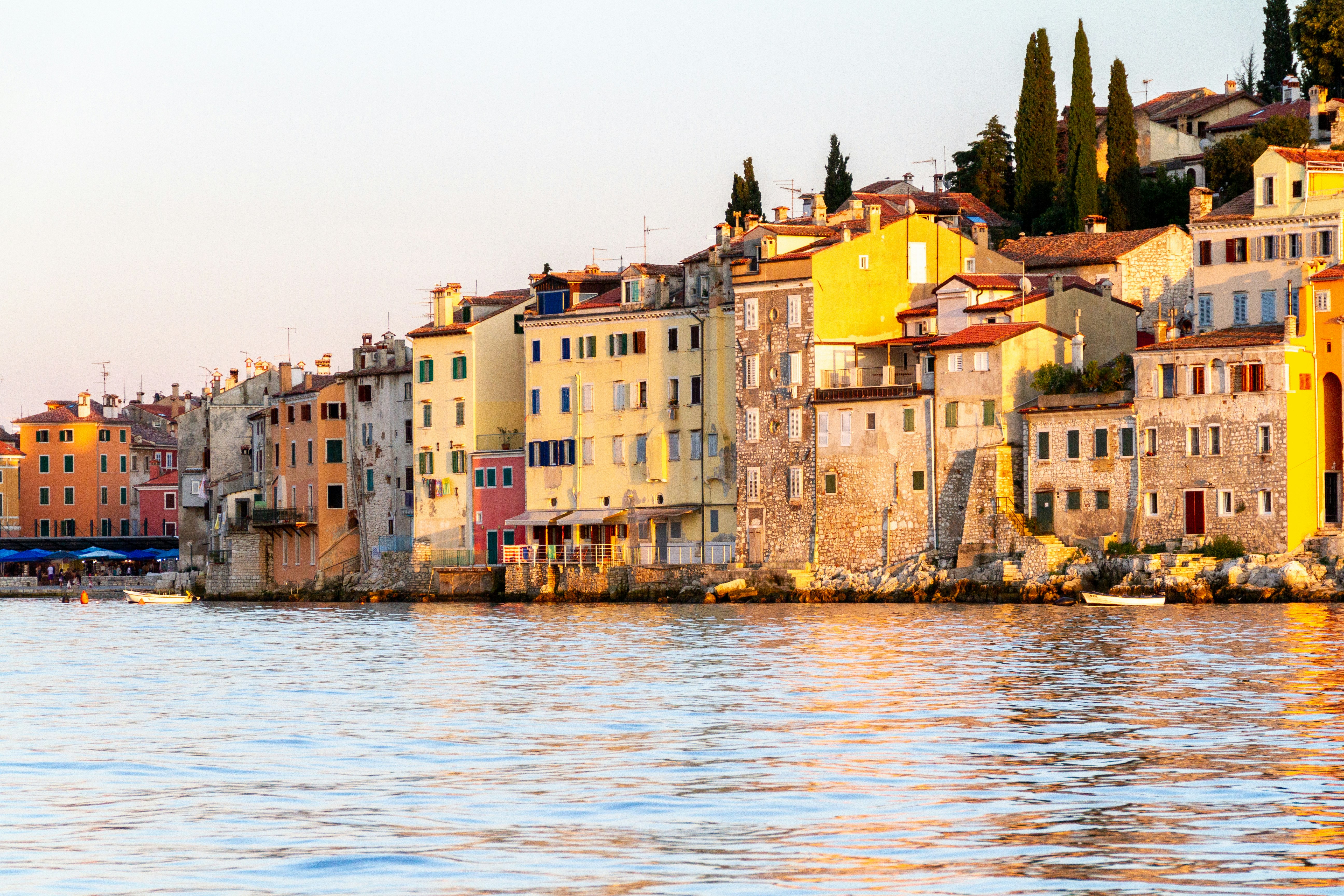 brown concrete building beside body of water during daytime